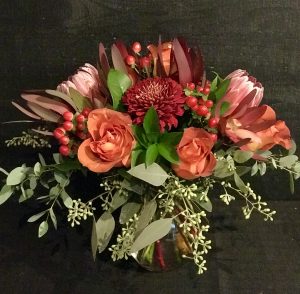 #3 Fall Mix. $75 Protea, deep orange roses, copper mums, seeded eucalyptus $75
